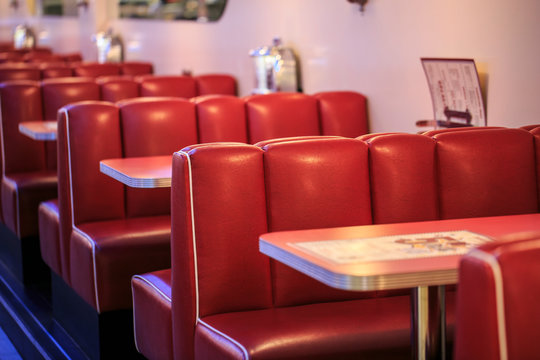 Red leather diner booth seating in restaurant setting showing commercial reupholstery work